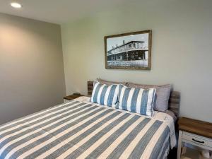 a bedroom with a bed and a picture on the wall at Harbor Hideaway Suite - River Rock Inn in Bellevue