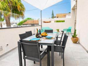 a dining room table and chairs on a patio at Villa Dolce Vita in Triscina
