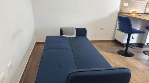a blue couch in a room with a desk at PiTer House - Luxury Apartments & Private Parking in Lusciano