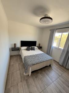 a bedroom with a bed and a large window at Las Magnolias CABAÑAS in Salta +18 photos