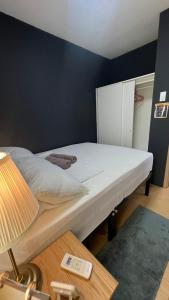 a bedroom with a large bed with a lamp and a table at 2BR Italian-inspired Condo Unit, Balcony Pool View in Manila