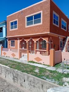 a brick building with a gate in front of it at Op paradise living in Kingston