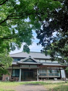 a building with a tin roof on top of it at Edo house in Shiigi