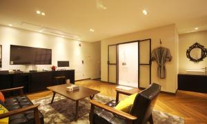 a living room with a couch and a table at Iksan 4 Seasons Hotel in Iksan +16 photos