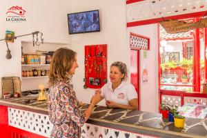 two women standing at a counter in a store at Hotel La Casona in Jardin +204 photos