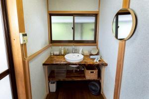 a bathroom with a sink and a mirror at Nagi no Ne in Washika +61 photos