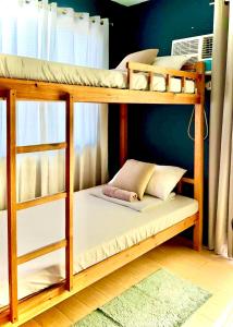 two bunk beds in a room with at 2BR Italian-inspired Condo Unit, Balcony Pool View in Manila