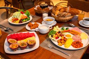 a wooden table with plates of food on it at Kacha Resort & Spa, Koh Chang in Ko Chang