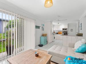 a living room with a couch and a table at Barefoot by the Bay in Iluka