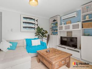 a living room with a couch and a coffee table at Barefoot by the Bay in Iluka