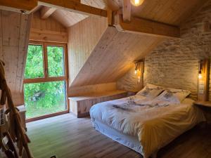 a bedroom with a bed and a large window at La R'mise de Surcey in Alaise +36 photos