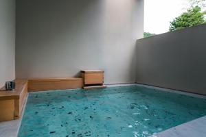 a room with a pool of water in the floor at Boscage Kariya in Yugawara