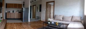 a living room with a white couch and a table at Apartment N22 in Leštane