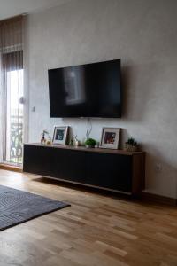 a living room with a flat screen tv on a wall at Apartment N22 in Leštane