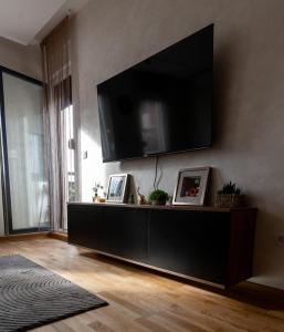 a living room with a large television on a wall at Apartment N22 in Leštane