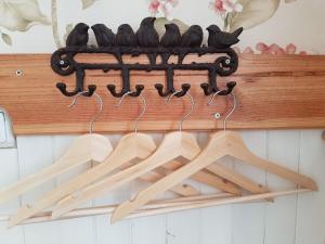 a group of woodensticks hanging from a wooden shelf at Cozy Sintra Townhouse in Sintra