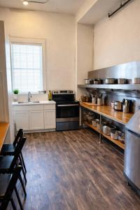 a large kitchen with a sink and a stove at Paddle Wheel Suite-Potter’s Mill in Bellevue