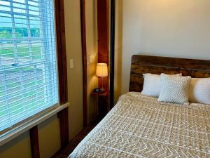 a bedroom with a bed and a large window at Paddle Wheel Suite-Potter’s Mill in Bellevue