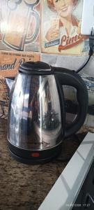 a tea pot with a picture on it sitting on a table at Hospedagem Dorna Itaguaí Casa 6B in Itaguaí +20 photos
