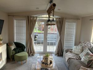 a living room with a couch and a table at Olive Tree Lodge in West Thirston