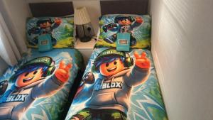 a bed with two twin beds in a room at Olive Tree Lodge in West Thirston +14 photos