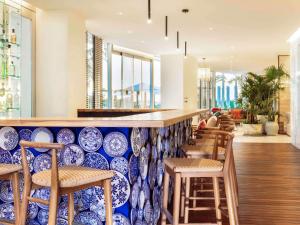 a bar with blue and white plates on the wall at SLS Cancun in Cancún
