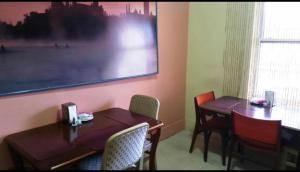 a dining room with a table and chairs and a picture on the wall at A Voyageur's Guest House in Ottawa