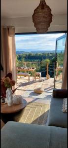 a living room with a view of a balcony at Domek DOMiarki in Klecza