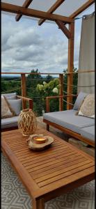 a room with a table and a bed on a balcony at Domek DOMiarki in Klecza