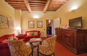 a living room with a couch and a tv at Borgo Sant'ippolito Country Hotel in Ginestra