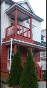 a red and white house with trees in front of it at A Voyageur's Guest House in Ottawa