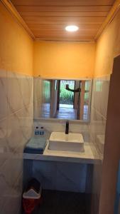 a bathroom with a sink and a mirror at SleepHere Homestay in Bayan