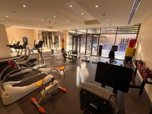 a gym with treadmills and machines in a building at Raha Inn Apartment in Aqaba