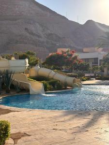 a water slide in a pool in a resort at Raha Inn Apartment in Aqaba
