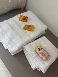 two white towels sitting on a table with a book at Studio in Barbacena