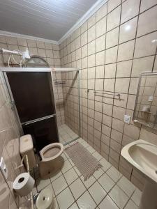 a bathroom with a toilet and a sink at Hostel Alto do Rosario in Vitória +14 photos