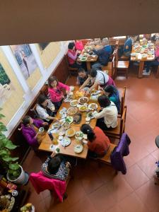 a group of people sitting at a table eating food at Ngan Nga in Bắc Hà