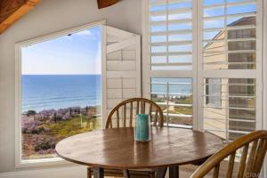 a table and chairs in a room with a large window at Solana Beach Resort in Solana Beach