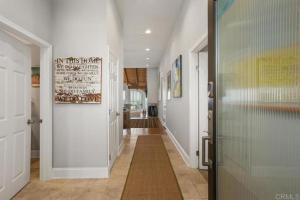 a hallway with a glass door in a house at Solana Beach Resort in Solana Beach