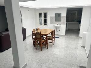 a dining room table and chairs in a room at La Maison D&N in Pondicherry