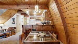 a dining room and kitchen in a cabin with a glass table at Cozy A-Frame Cabin in Downtown McCall in McCall