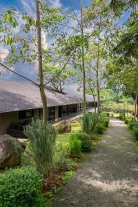 a building with a pathway in front of it at Spring River Cisarua in Paragajen