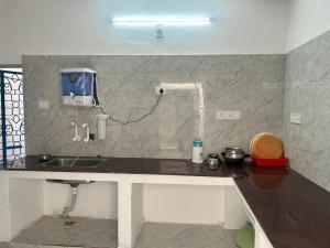 a kitchen with a sink and a counter top at La Maison D&N in Pondicherry