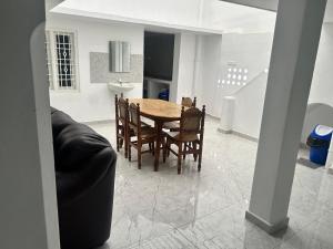 a kitchen and dining room with a table and chairs at La Maison D&N in Pondicherry +10 photos