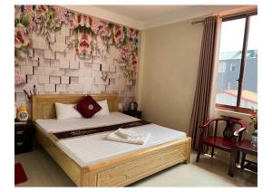 a bedroom with a bed with a flower wall at Ngan Nga in Bắc Hà +8 photos