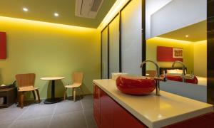a bathroom with a sink and a counter with chairs at Incheon Pentastar Hotel in Incheon +31 photos