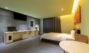 a hotel room with a bed and a sink at Incheon Pentastar Hotel in Incheon