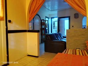 a living room with a couch and a living room with a couch at Cabanon plage david in Bouznika