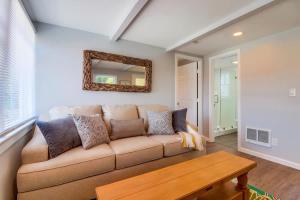a living room with a couch and a mirror at Bette's Bungalow in San Diego