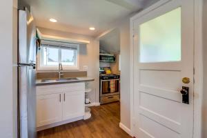 a kitchen with a white door and a sink at Bette's Bungalow in San Diego